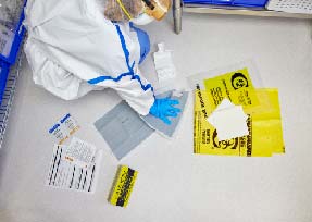 Cleanroom employee cleaning hazardous drug spill with spill kit and full PPE